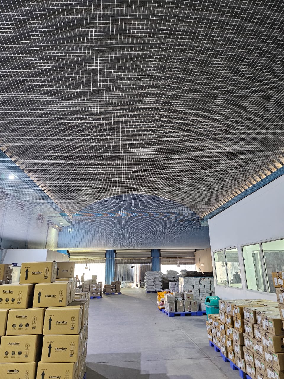 Warehouse ceiling bird netting over curved roof